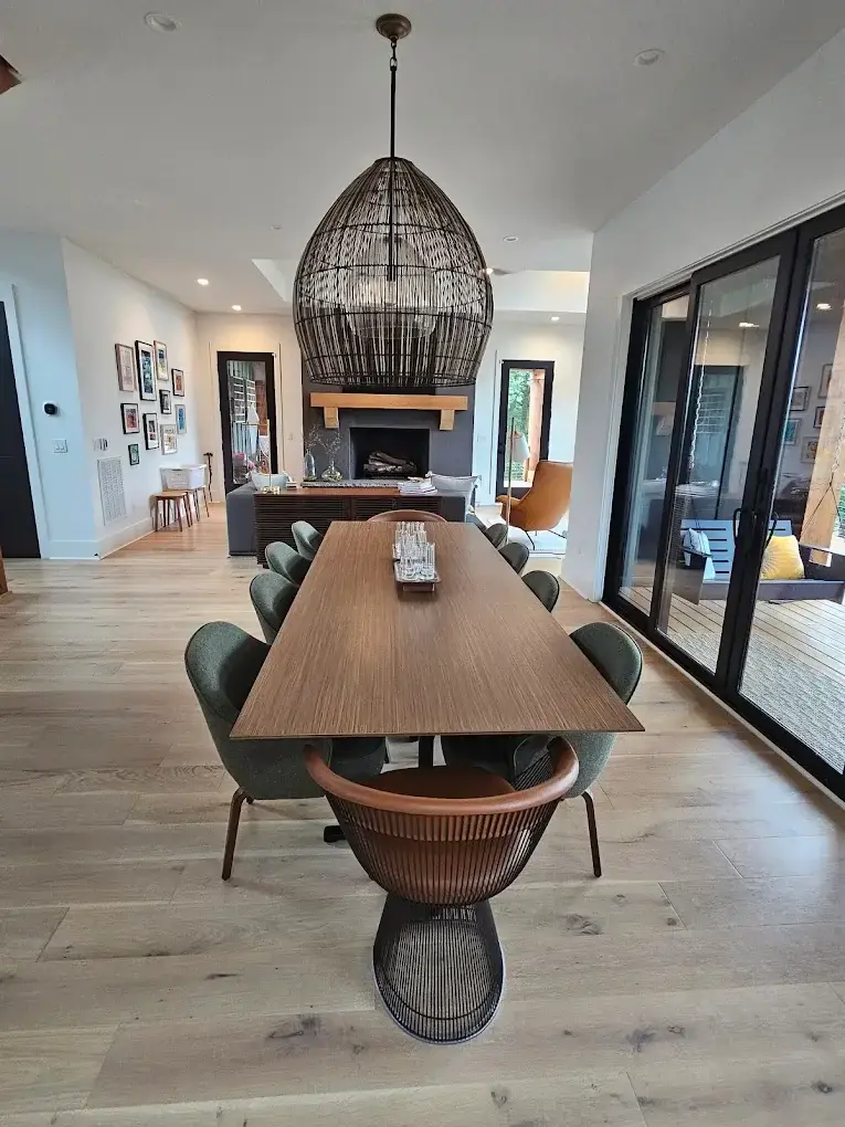 Open dining room with long wood table cleaned by Heaven Scent