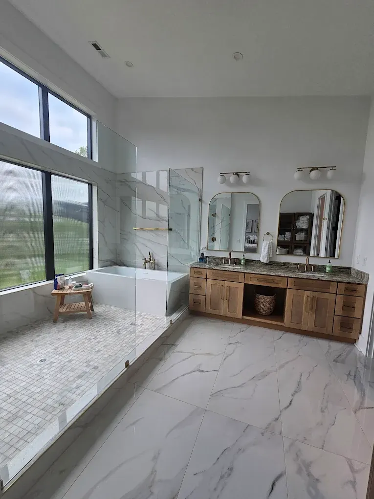 Sparkling clean bathroom with round mirror and spotless vanity, cleaned by Heaven Scent Cleaning Service